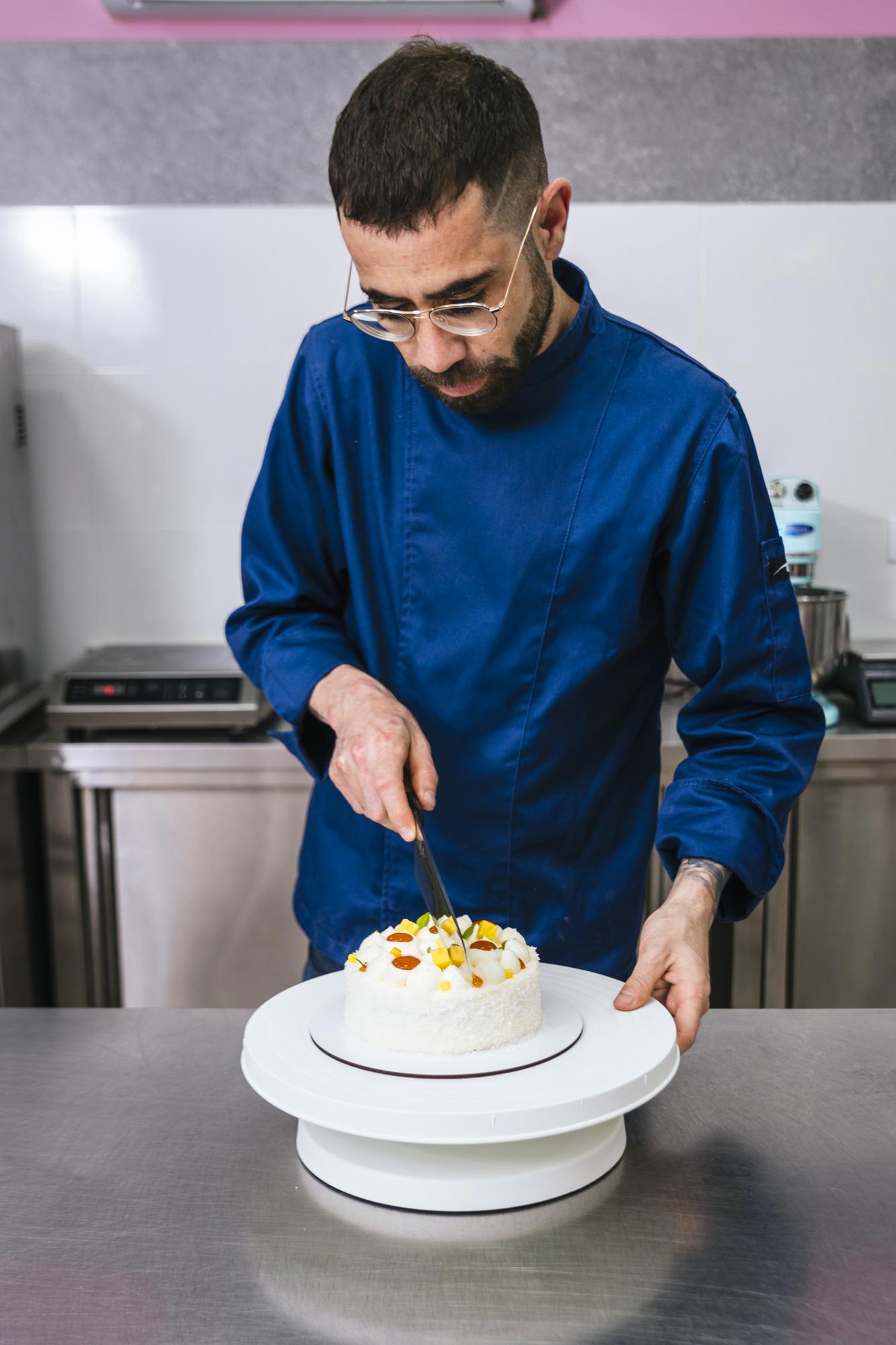 Portrait of head chef plating a dish